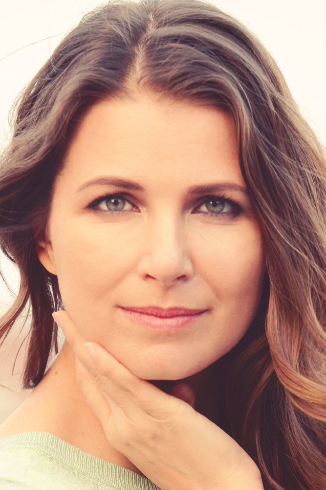 Photo of brunette woman with hand on chin